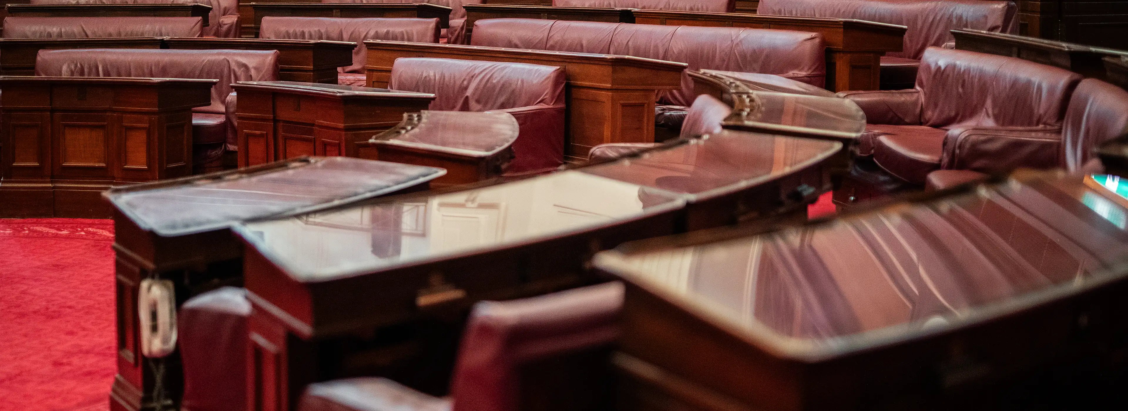 Empty wooden benches and desks in a courtroom