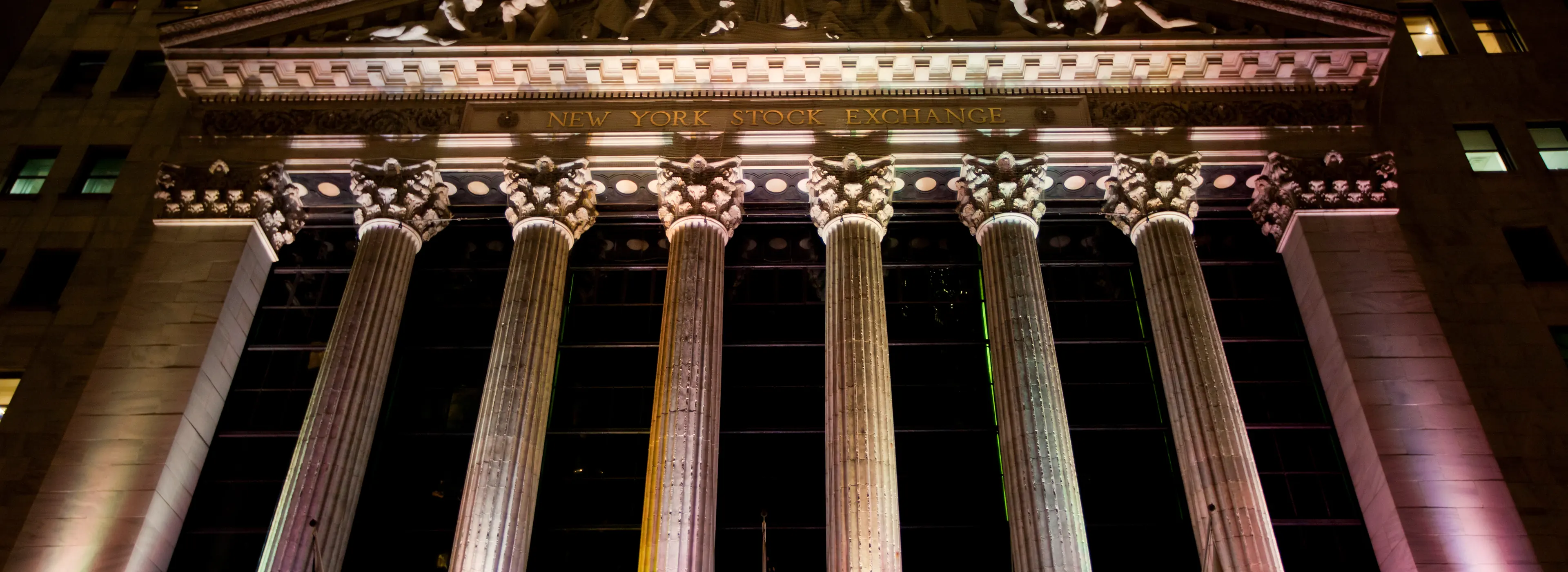 The New York Stock Exchange facade lit at night